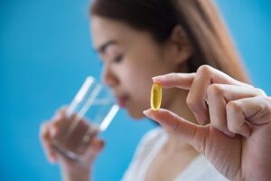 woman hand holding a pills take medicine according to the doctor's order
